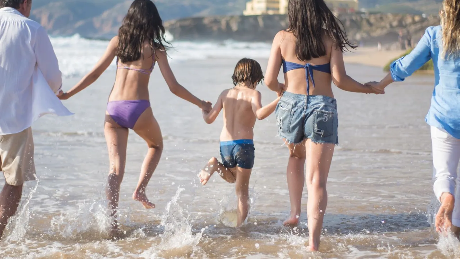 A family running into the sea together